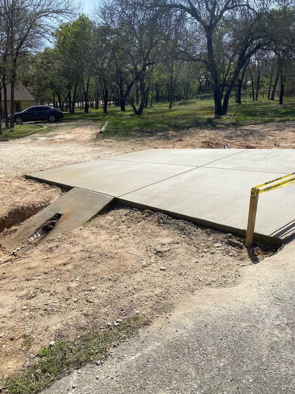 concrete driveway with drainage culvert